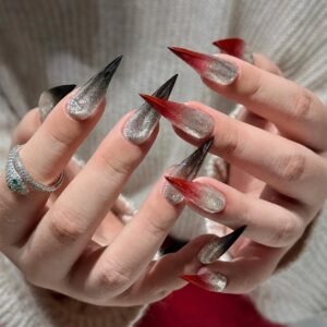 Model hands with long red silver gradient stiletto press on nails and silver ring