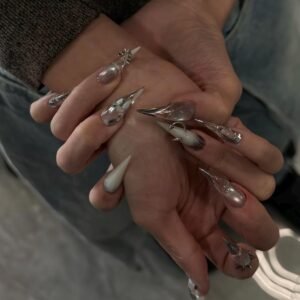 Close-up of luxury silver metallic press-on nails with crystal nail art