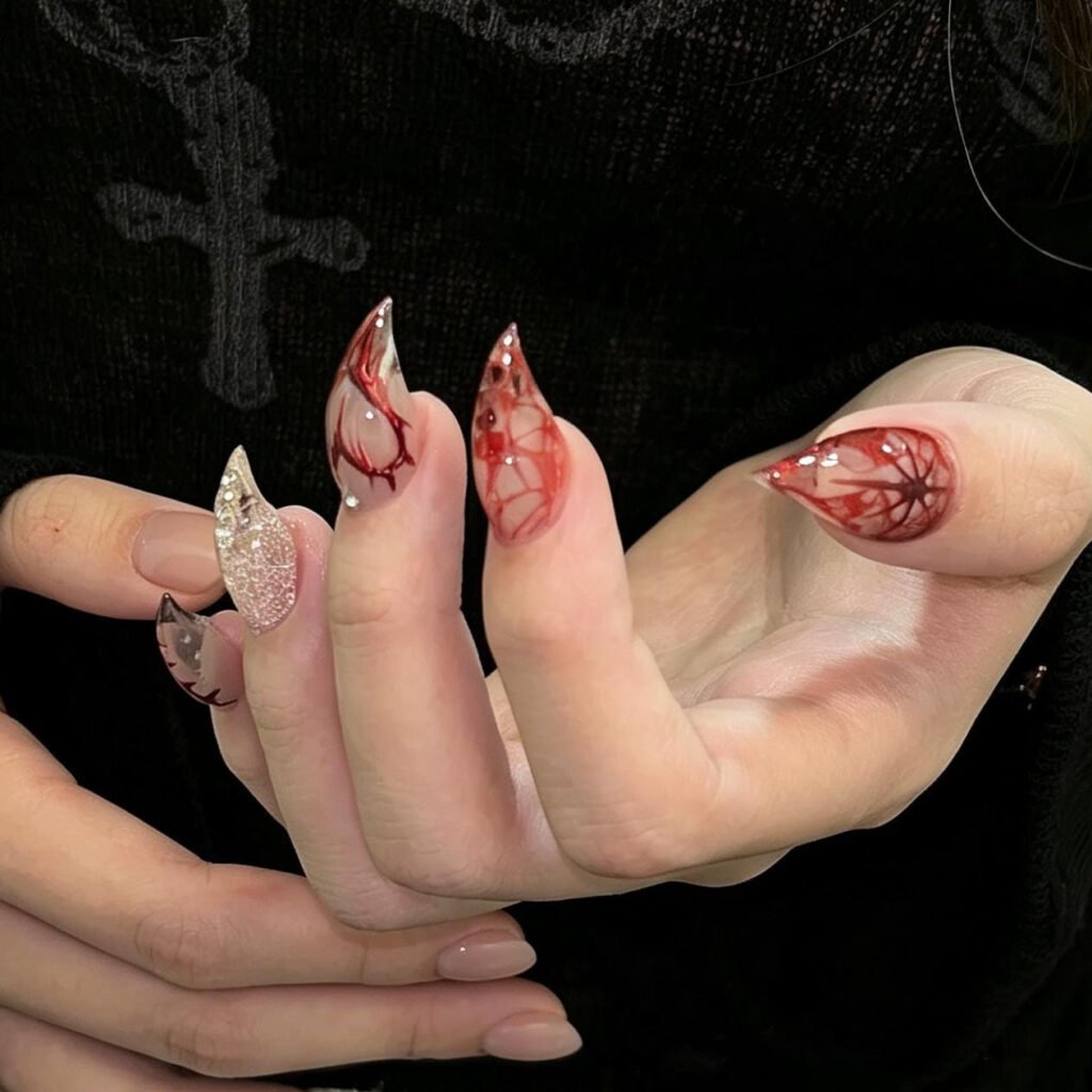 Close-up of 3D red rose nail art on glossy black press-on nails