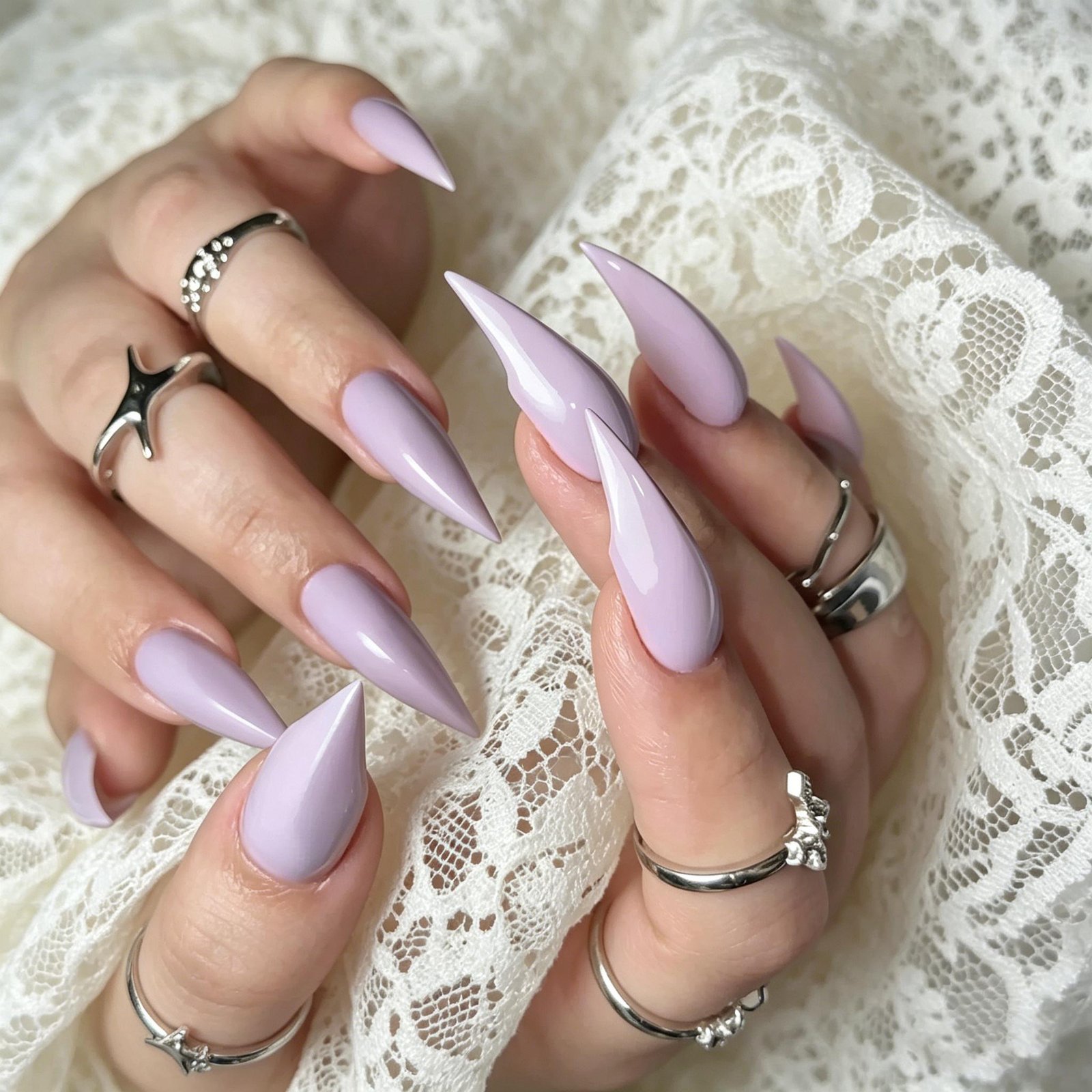 Handmade purple lavender press-on nails with chrome details and glossy almond stiletto shape