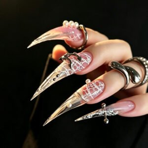 Extra-long stiletto press-on nails with pink marble design, gold accents, and 3D floral embellishments
