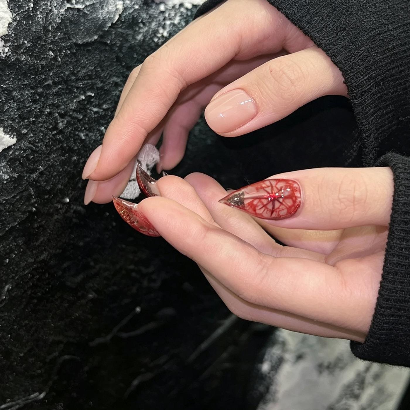 Close-up of red 3D flower accent on black press-on nail
