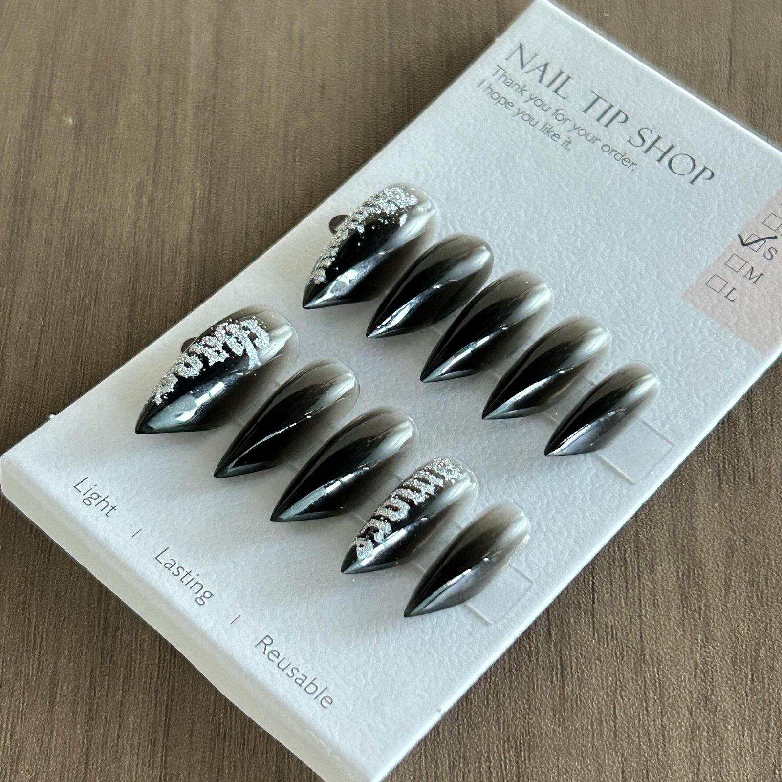 Complete set goth black silver graffiti stiletto reusable press on nails flat lay