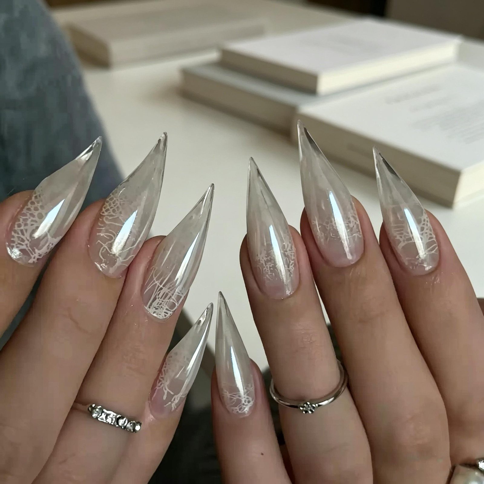 Long white chrome stiletto press-on nails with glossy pearl finish and luxury design